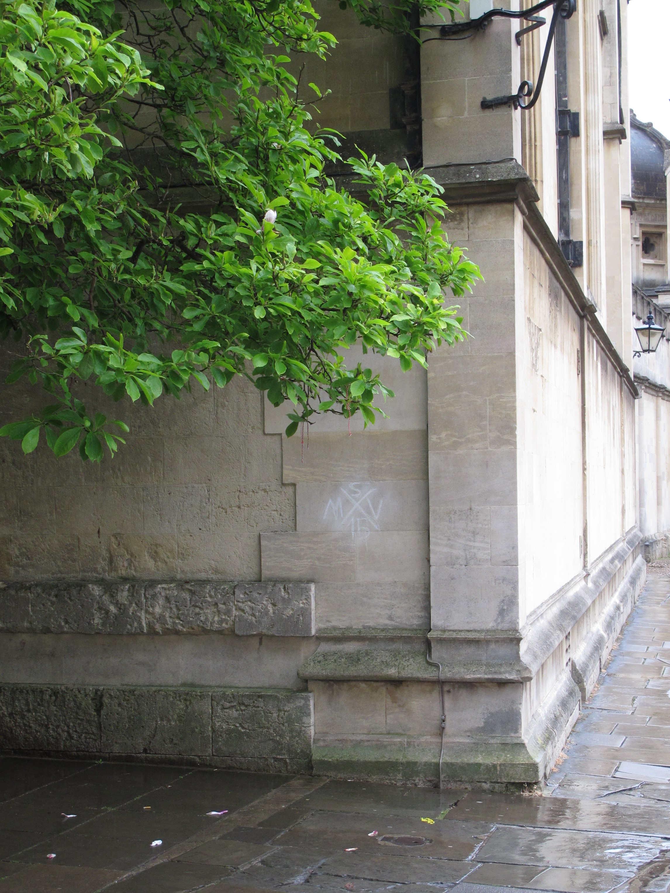 Corner of building at the end of Catte St. looking into Radcliffe Square, with scuffed chalk mark visible on the wall